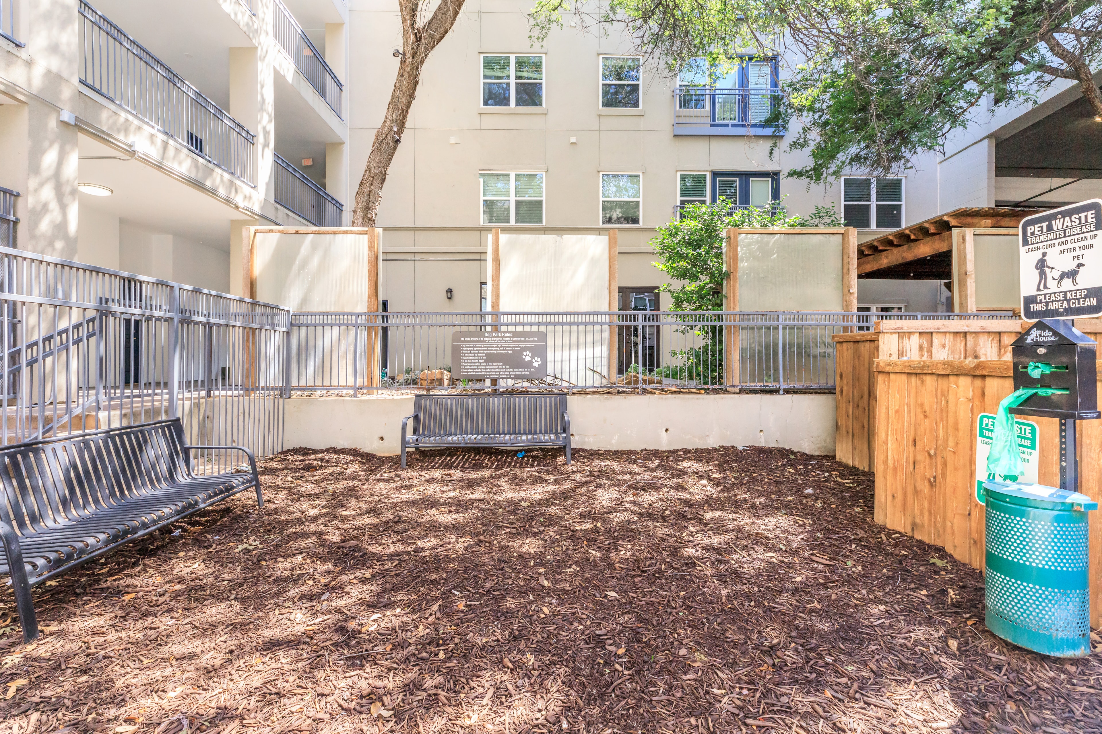 Outdoor dog park with benches and waste stations