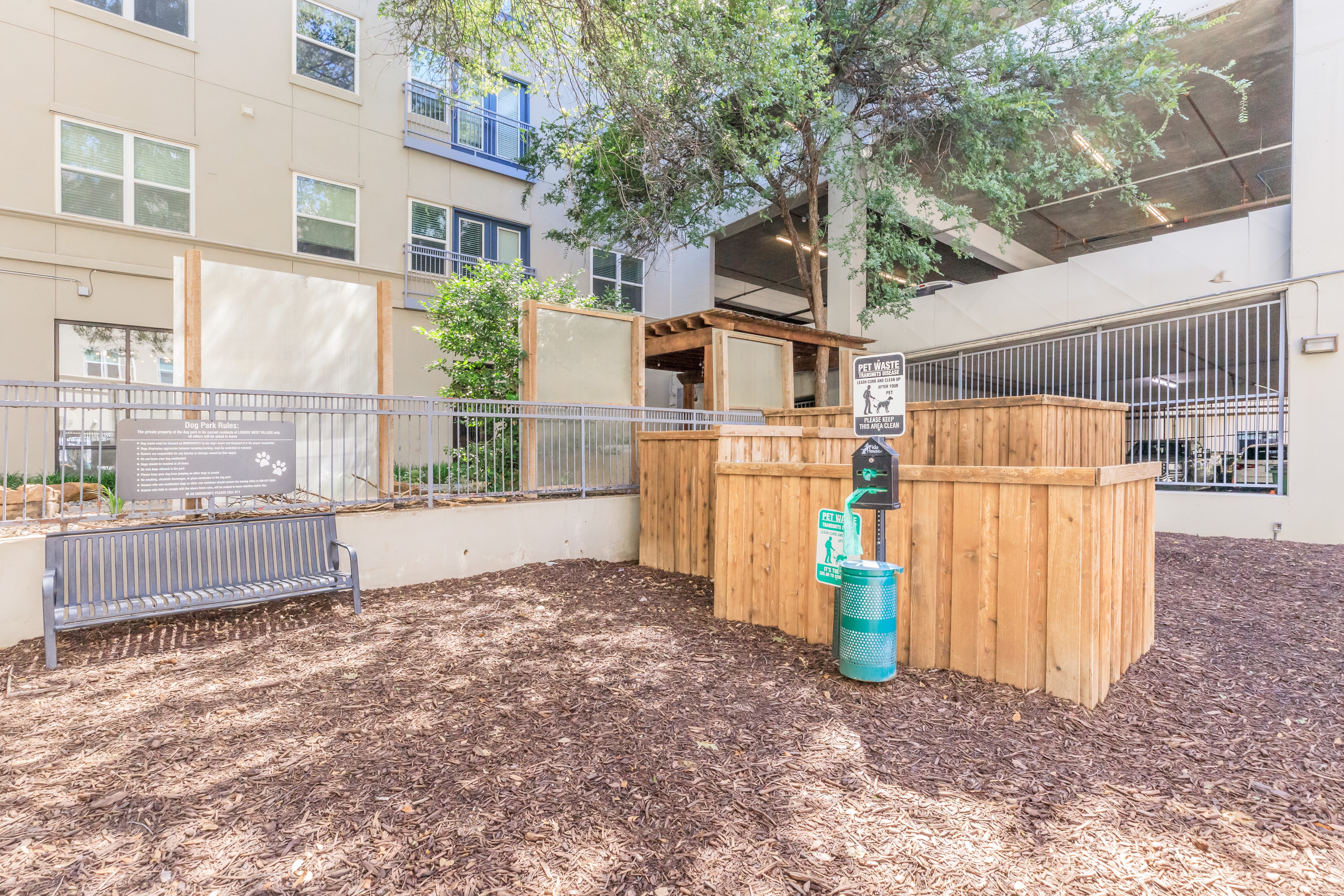 Dog park with wooden pergola and pet waste station