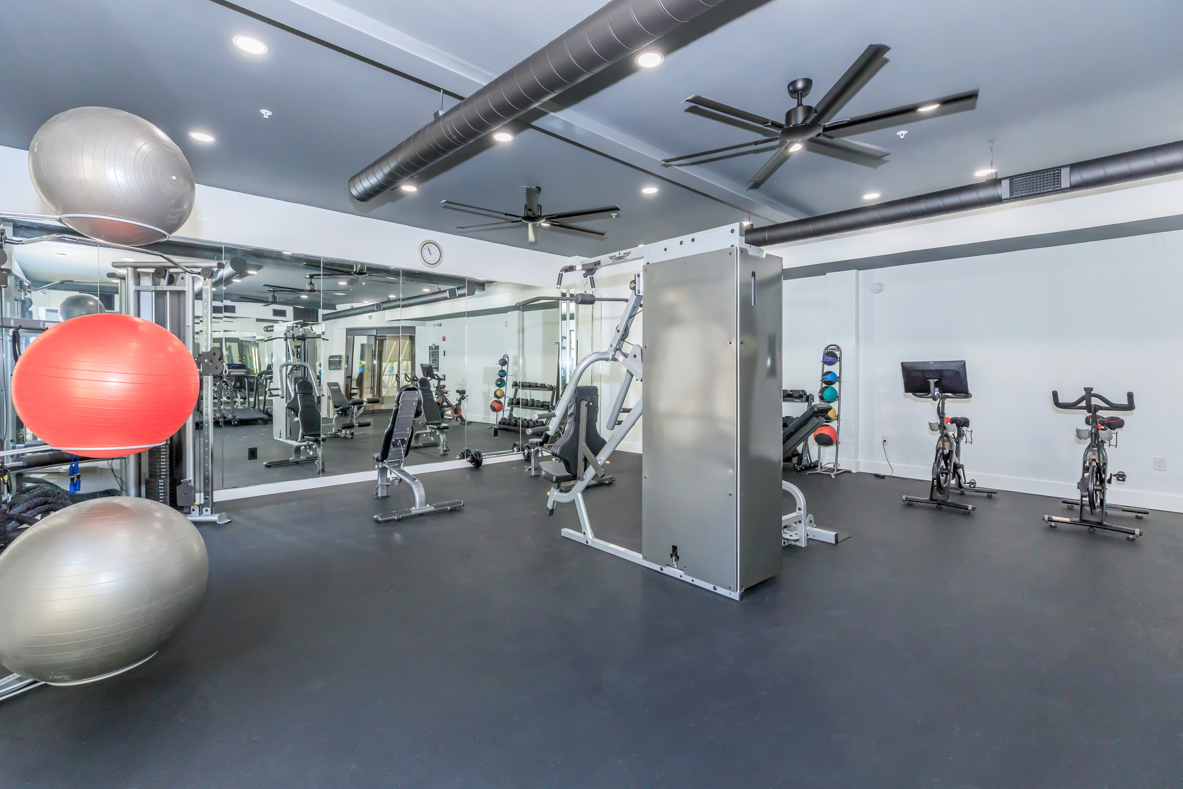 Fitness center with free weights, cable machine, and spin bikes
