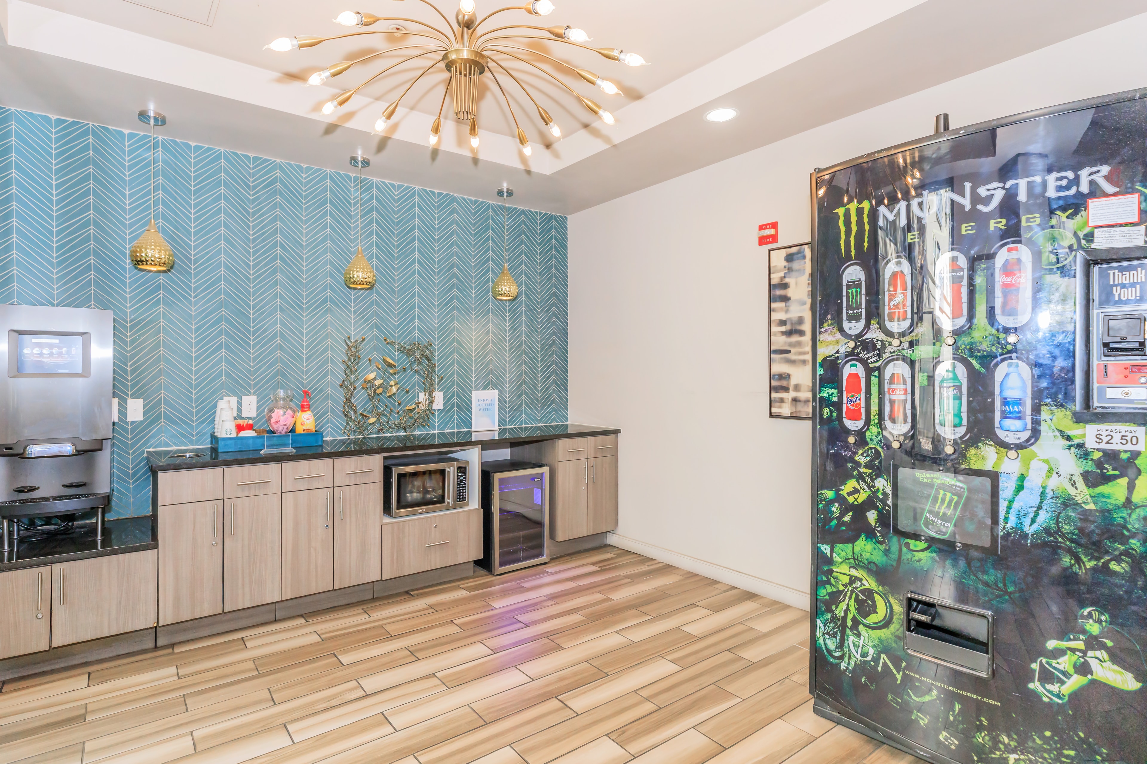 Resident lounge with teal herringbone wall and vending machine