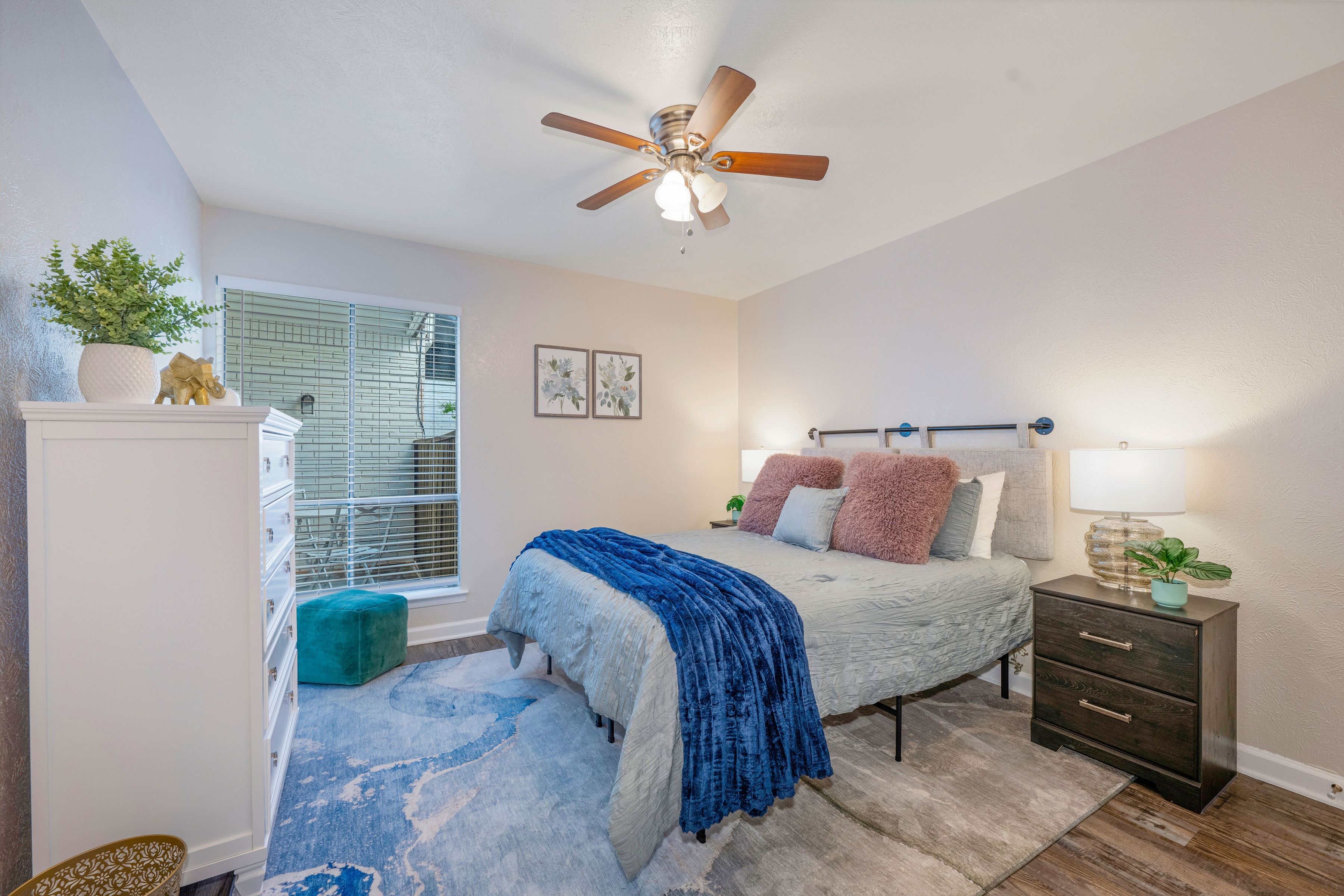 Bedroom with ceiling fan and patio window