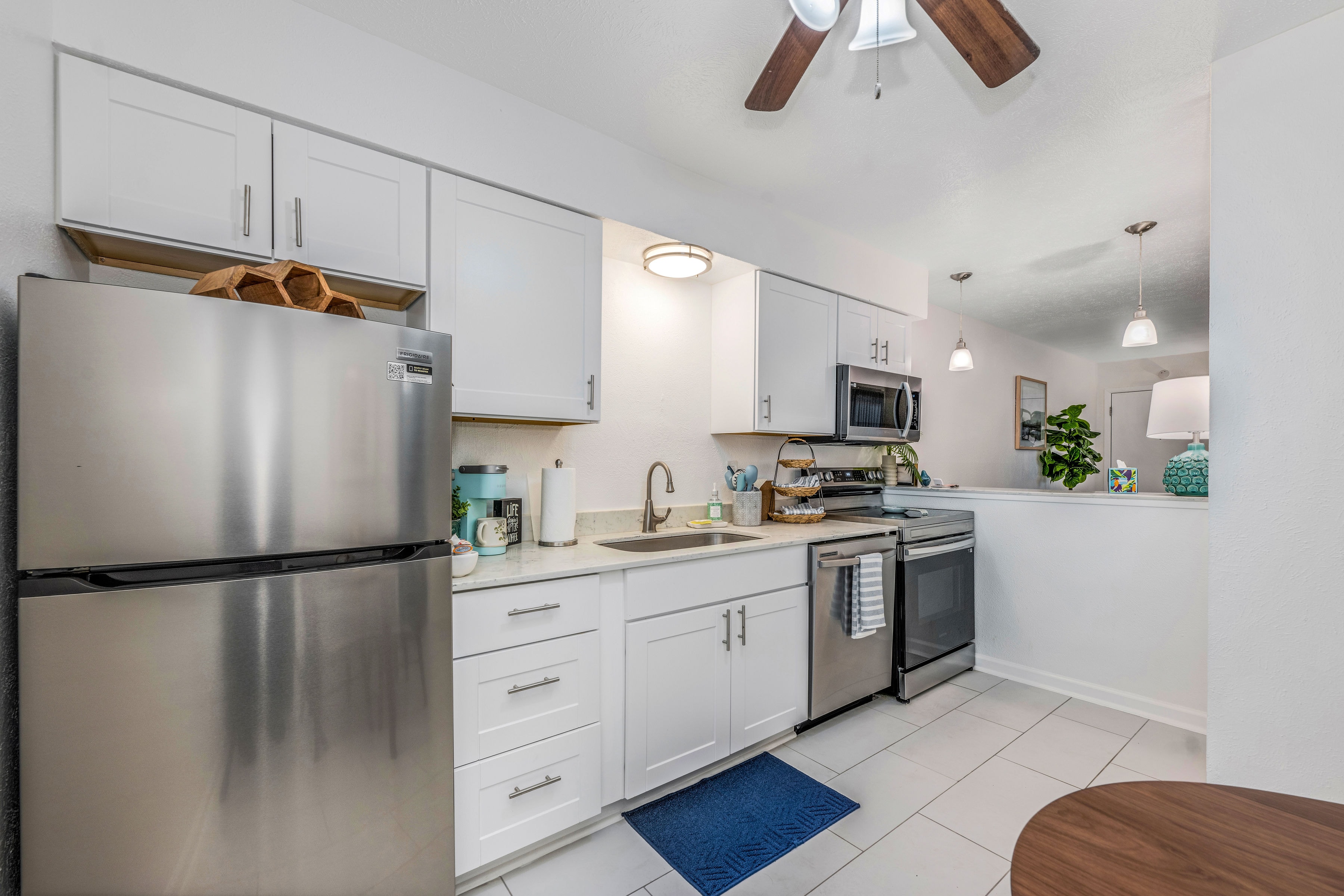 Kitchen with ceiling fan and dining table