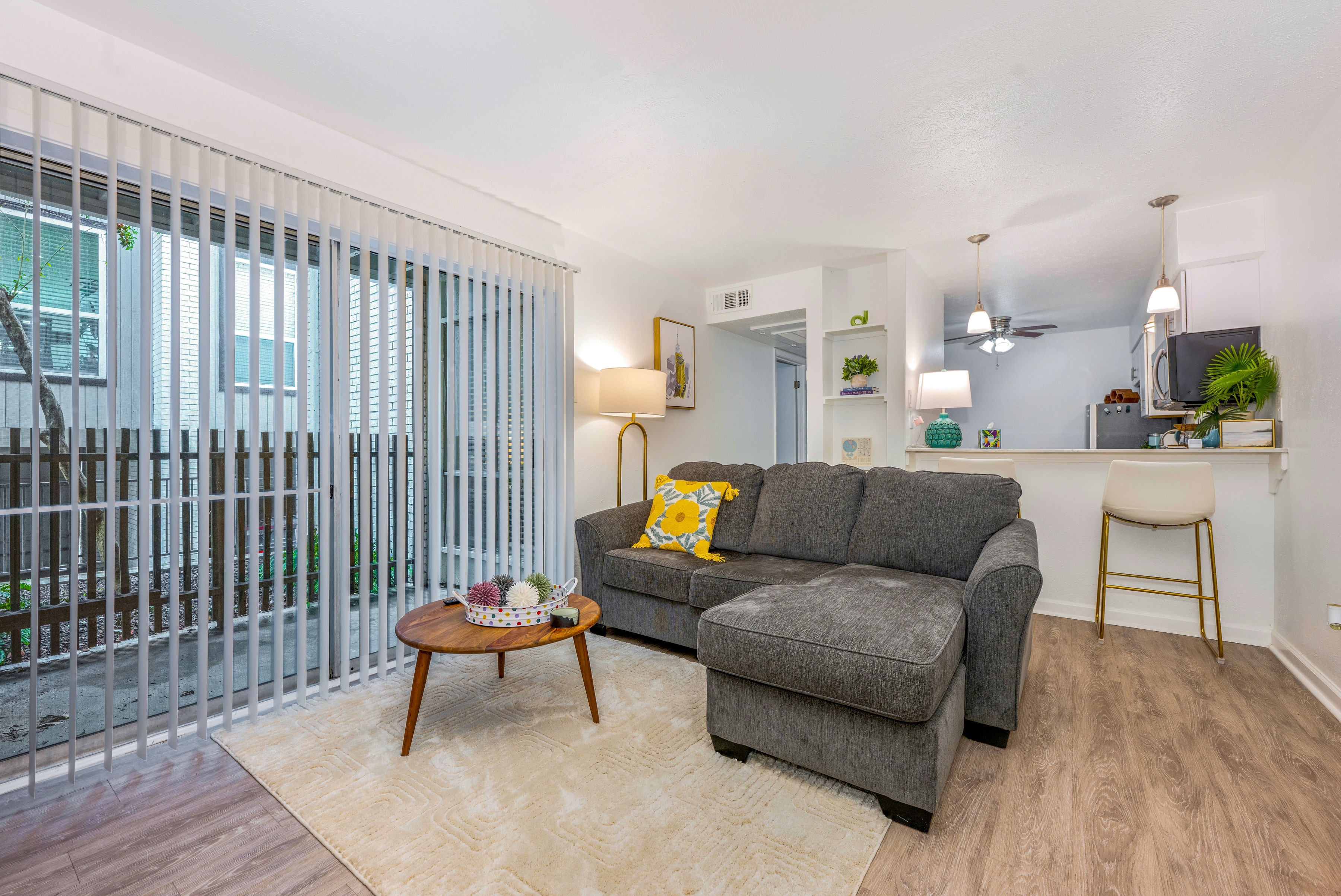 Living room with gray sectional sofa and patio doors